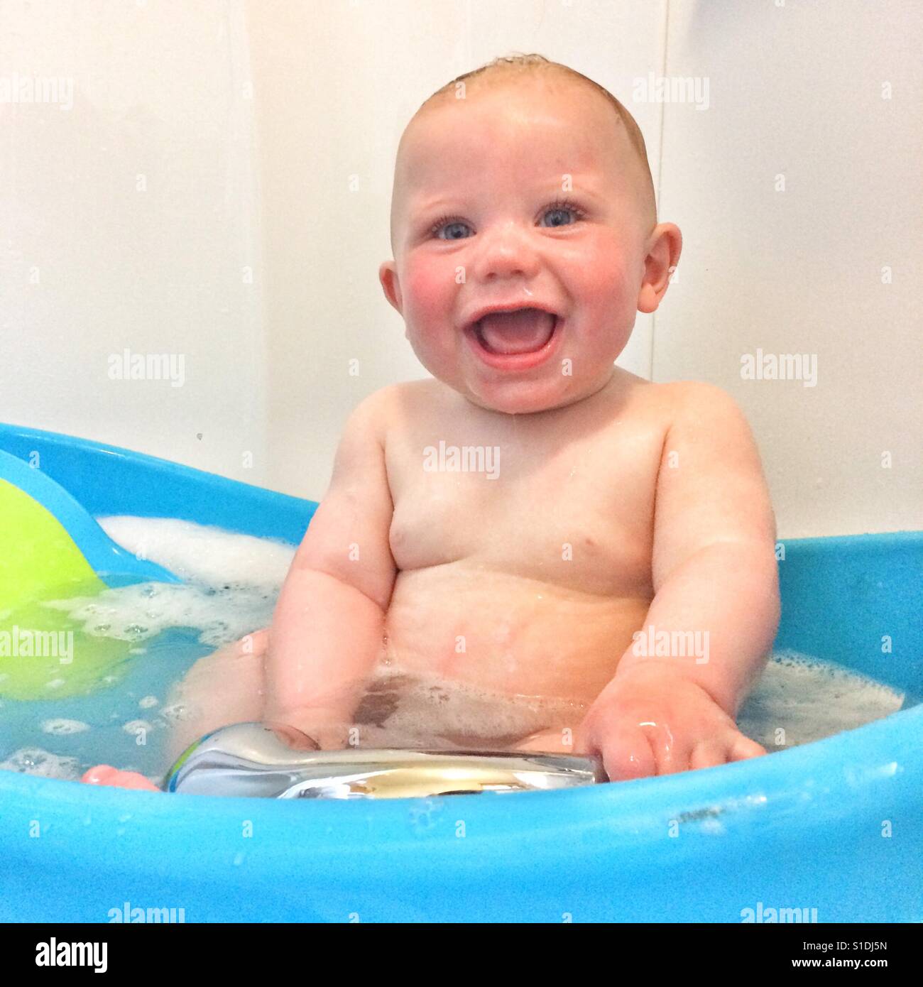 Seven month old baby boy having a bath Stock Photo Alamy