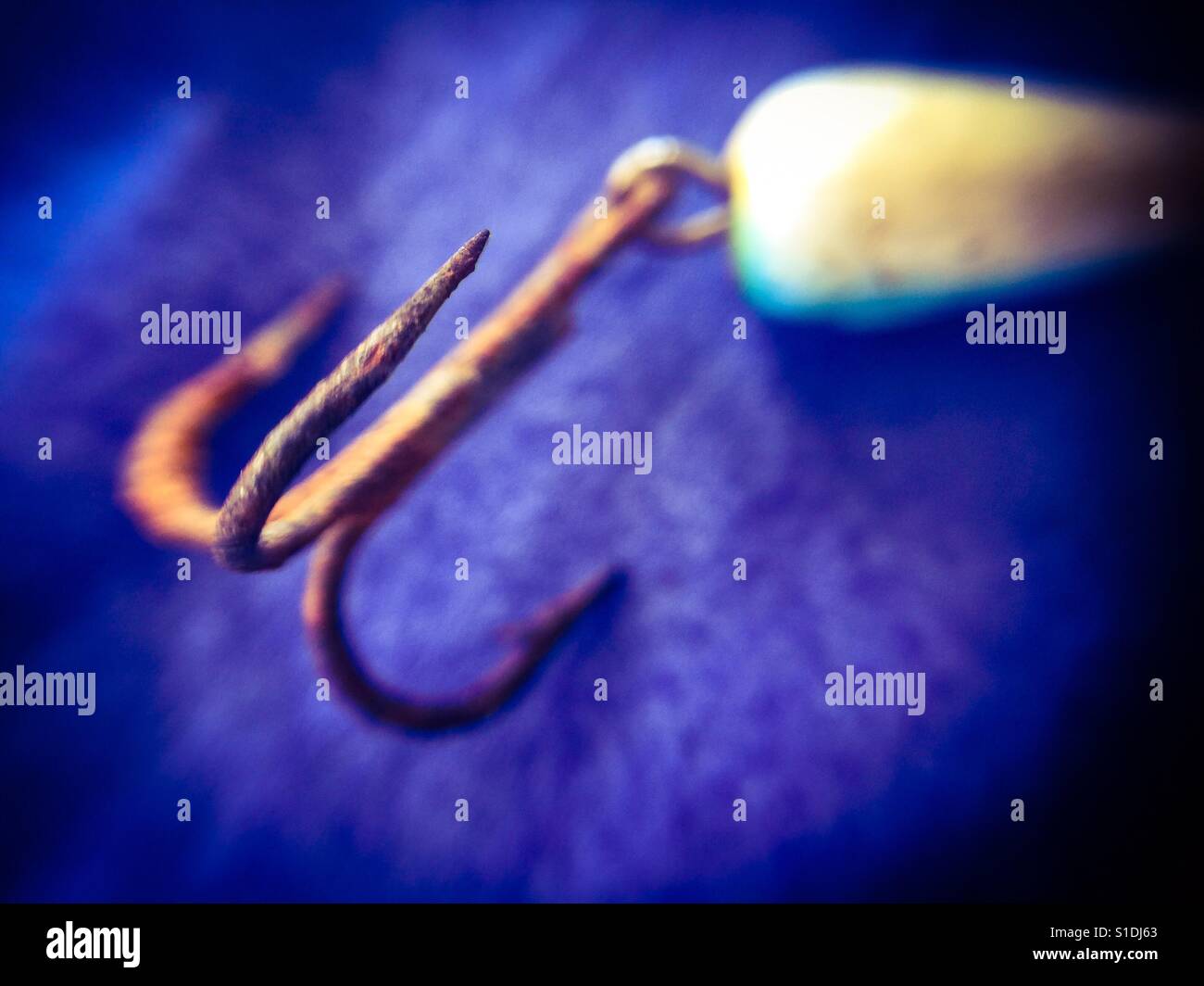 Rusted small fishhook with a floater on a plain background. From another era. Nova Scotia, Canada. - Smartphone Captured Stock Image