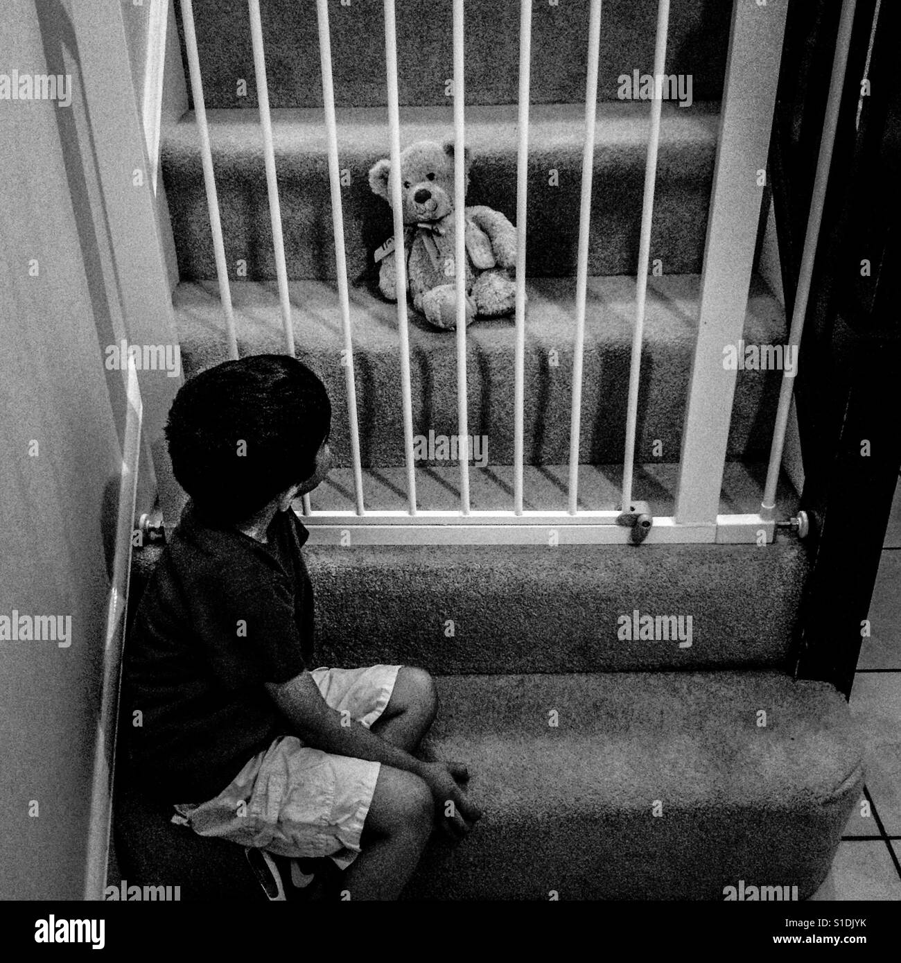 Naughty time and teddy's behind bars!! The child longs for him... Stock Photo