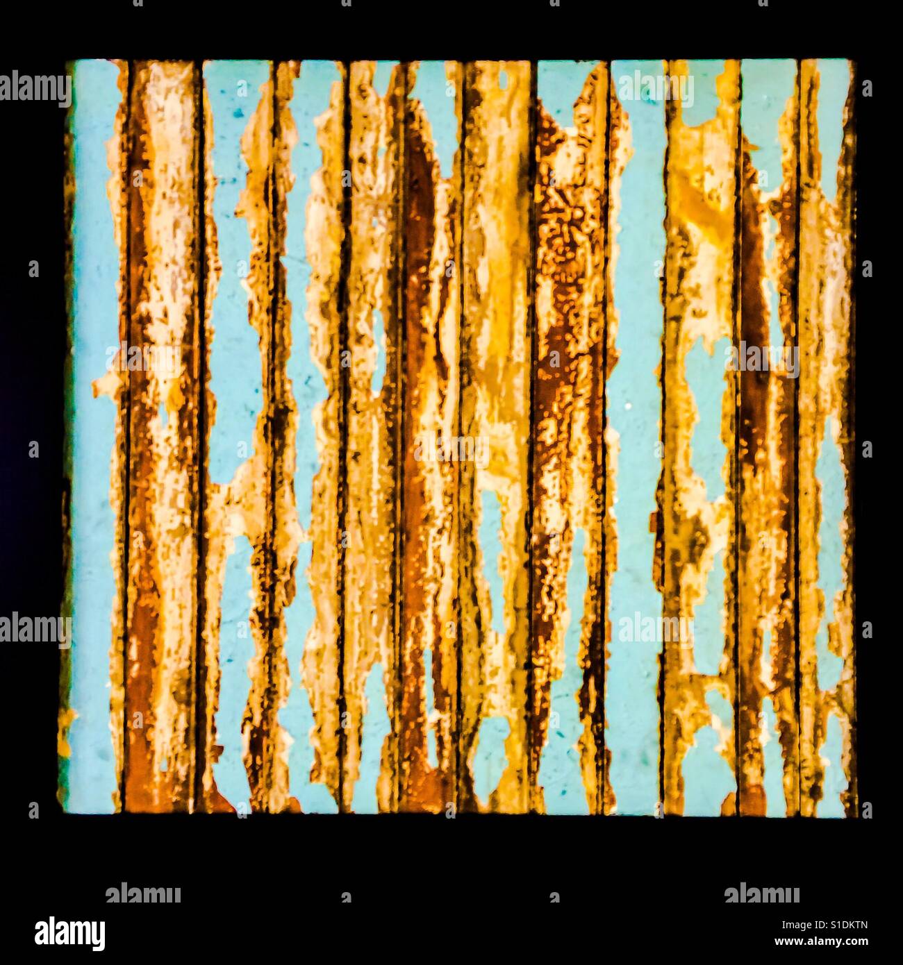 Recycled art: peeling, flaking strips in a black frame - Smartphone Captured Stock Image