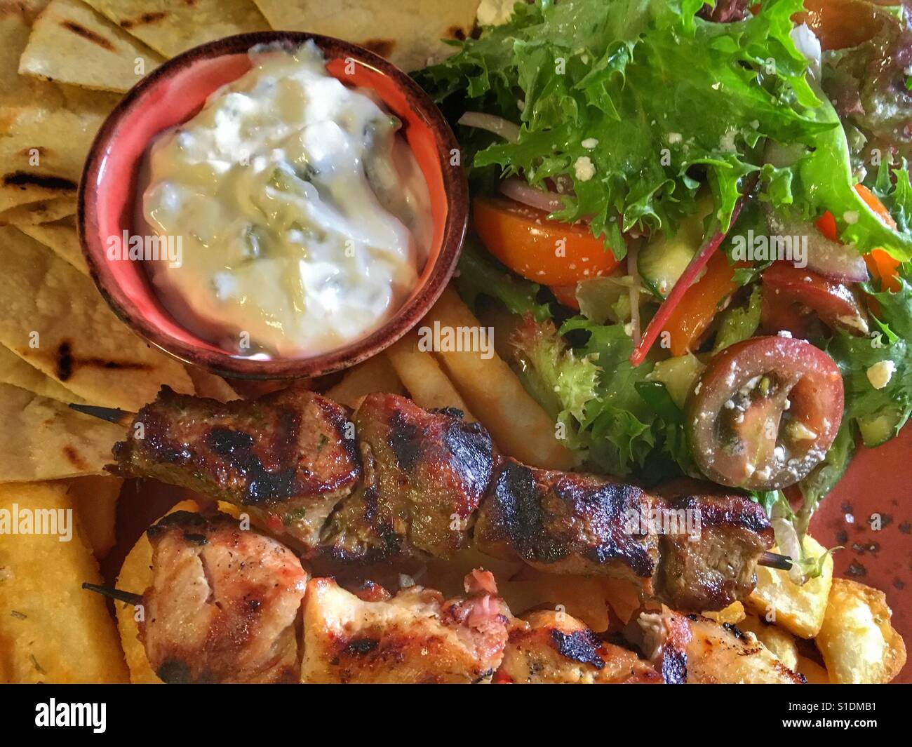 Souvlaki, peta, salad, hot chips & sauce' Stock Photo