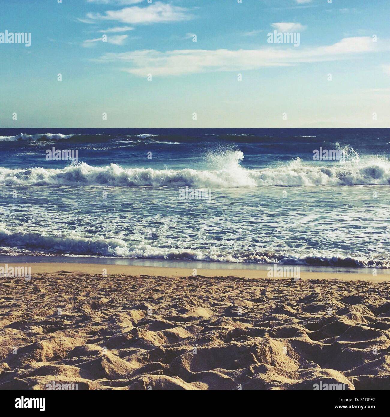 Looking at the ocean off a sandy beach. Square crop. Space for copy. - Smartphone Captured Stock Image