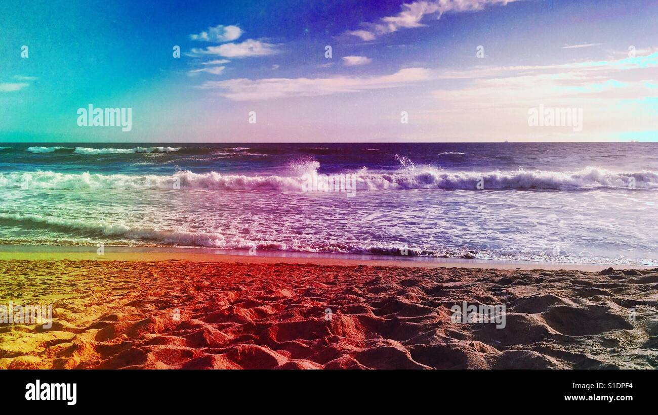 Looking at the ocean and horizon from a sandy beach. 16x9. Colour filter. - Smartphone Captured Stock Image