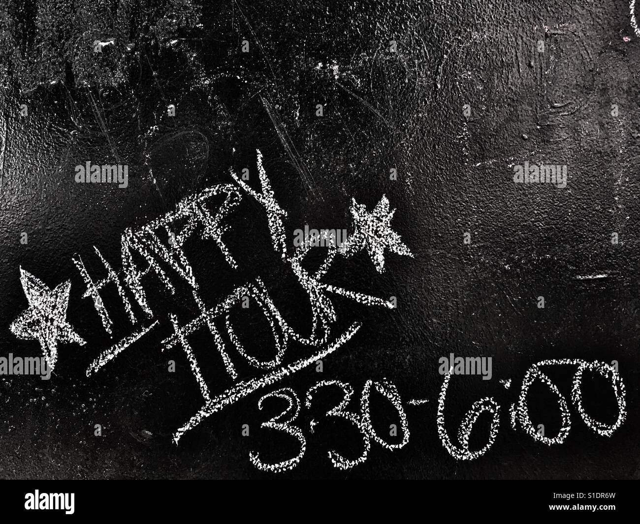 Happy hour on bar chalk board - Smartphone Captured Stock Image
