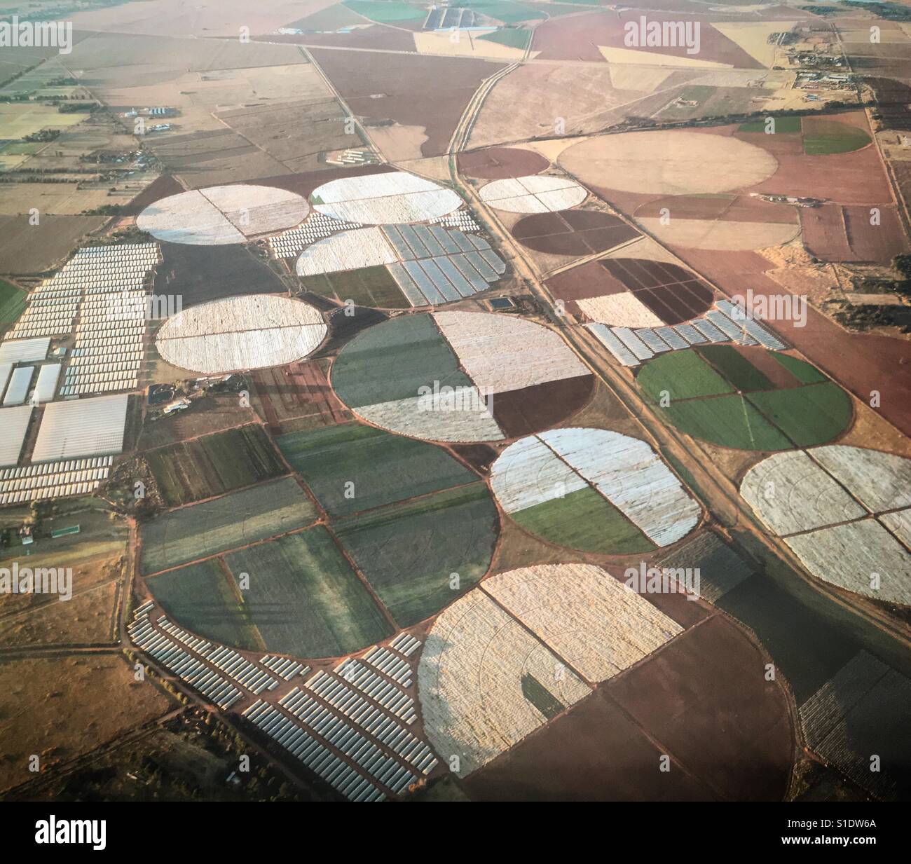 Aerial photo of circular irrigation crop fields on a farm. Stock Photo