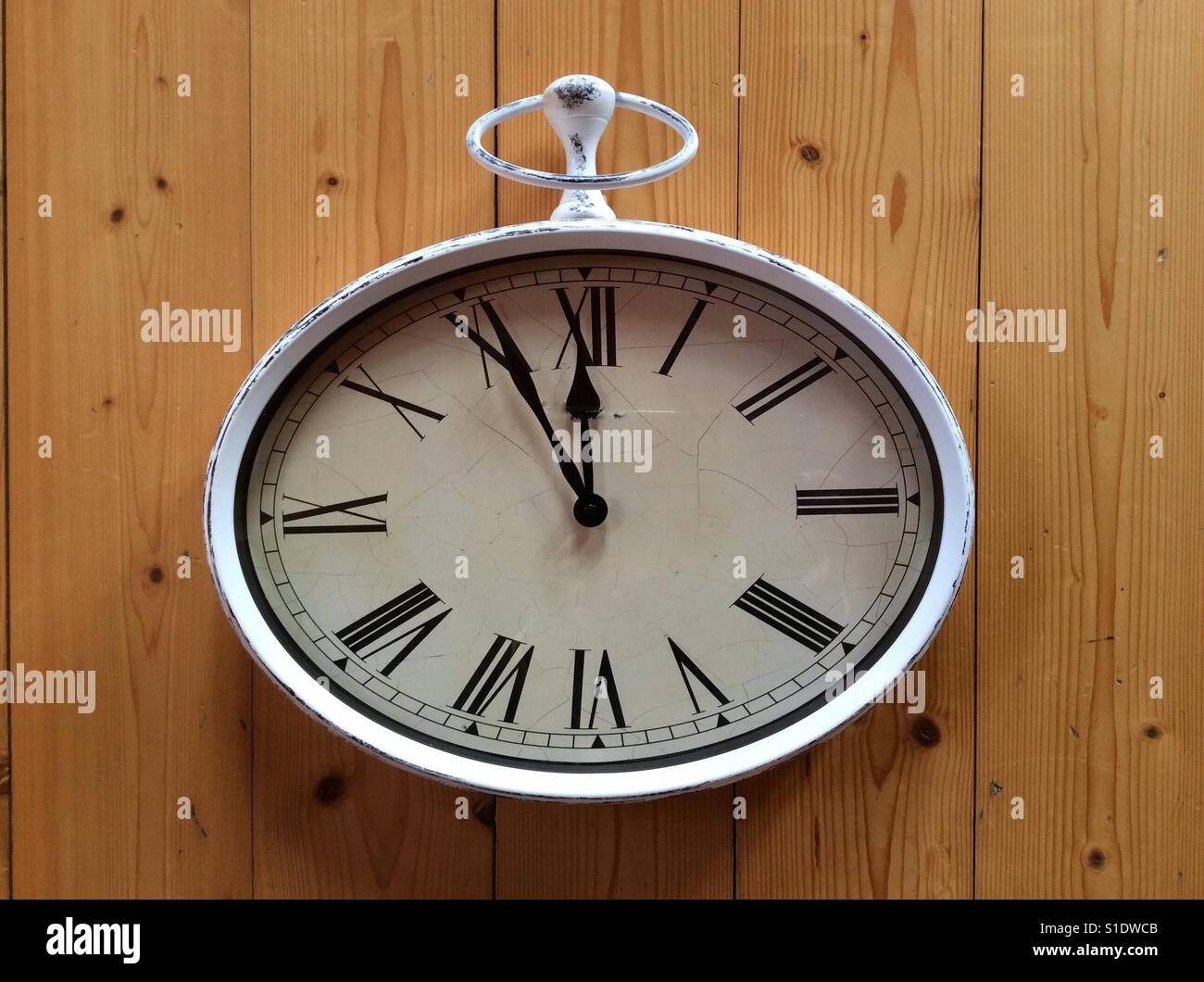 Vintage clock at 5 minutes to 12 Stock Photo