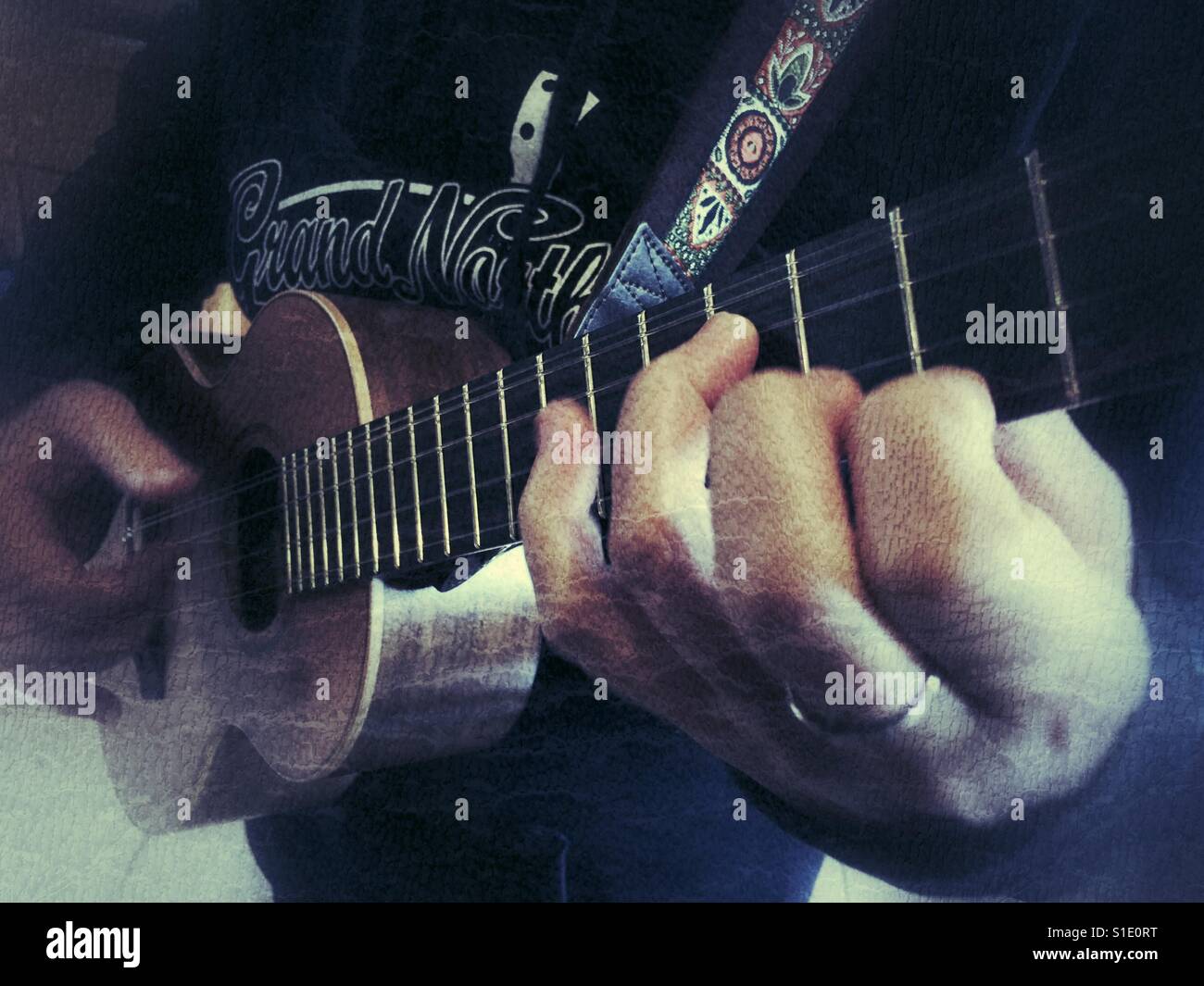 Close up of woman playing  a 5 string tenor ukulele - Smartphone Captured Stock Image