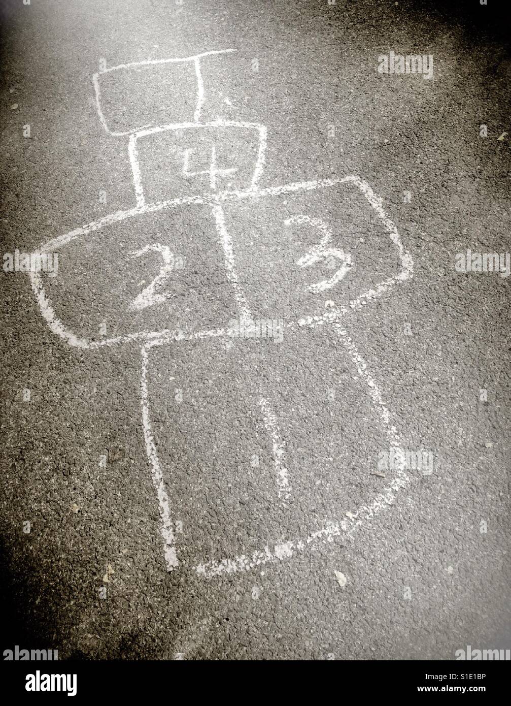 Unfinished hopscotch game on concrete sidewalk in chalk, USA Stock