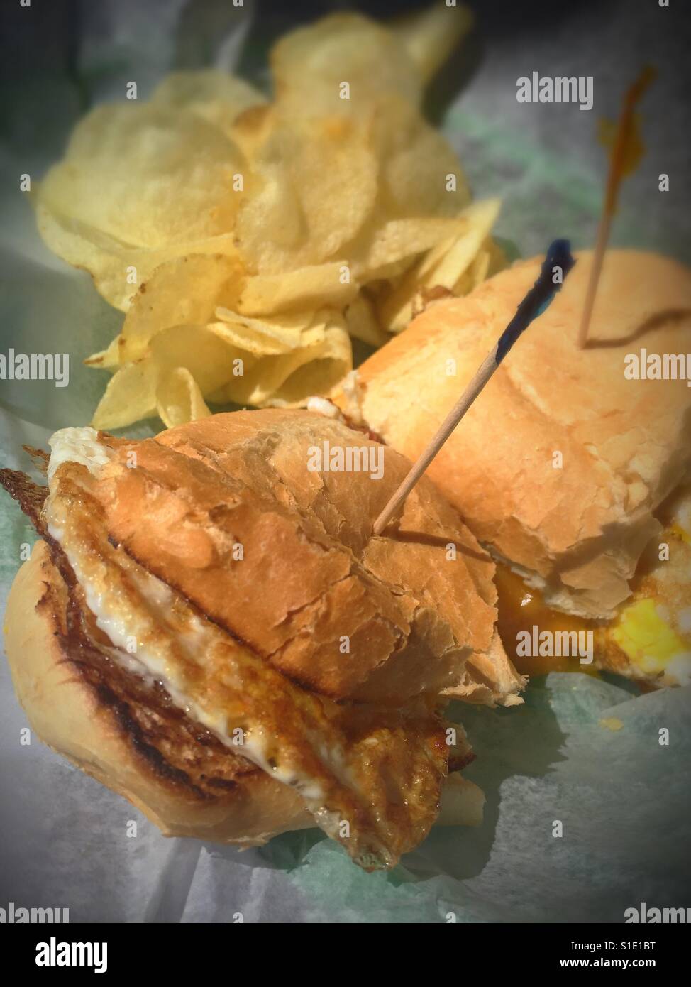 Egg sandwich on a roll with potato chips, USA. - Smartphone Captured Stock Image