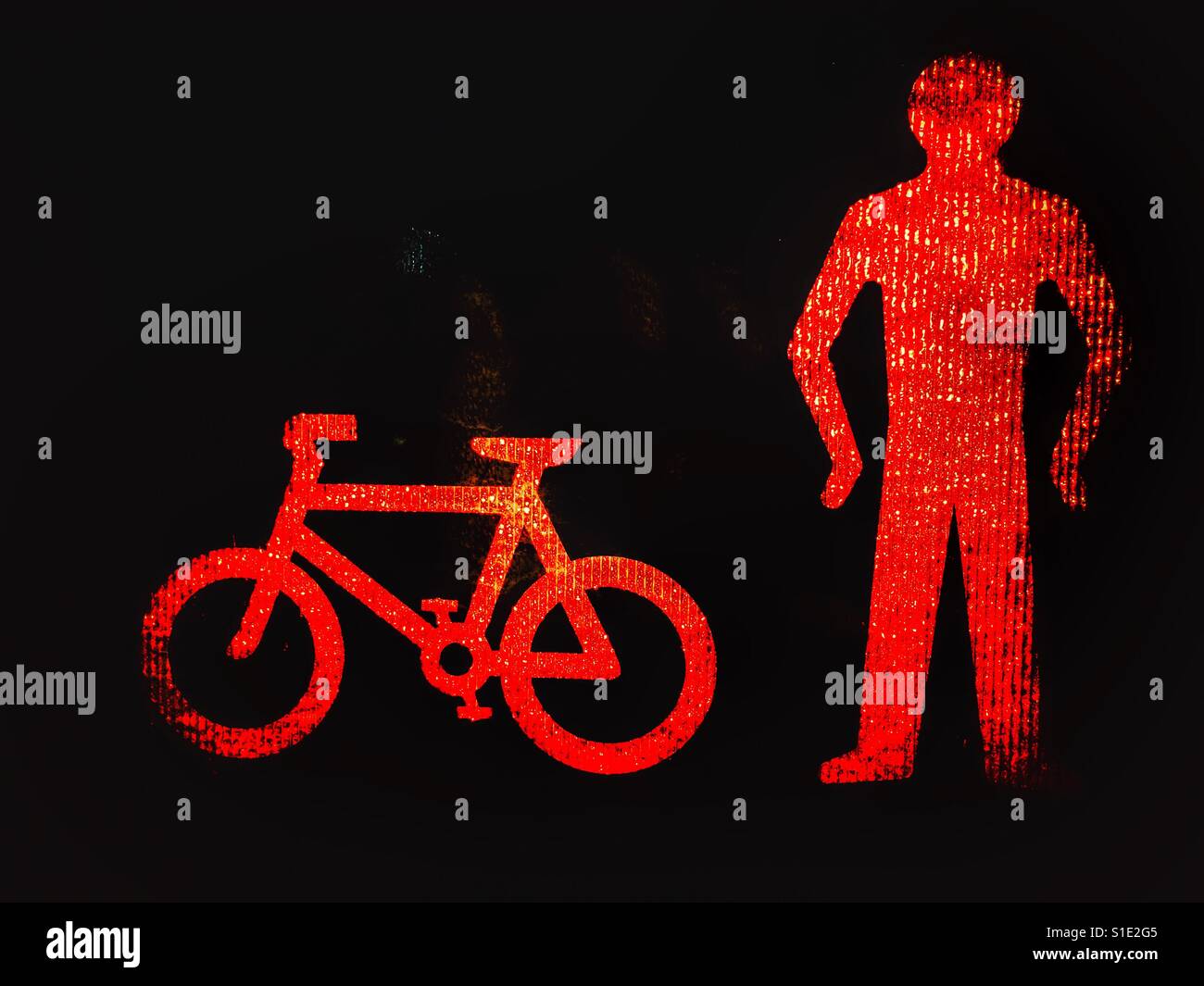 Pedestrian crossing. Red light on man and bicycle, indicating not safe to cross the road. - Smartphone Captured Stock Image