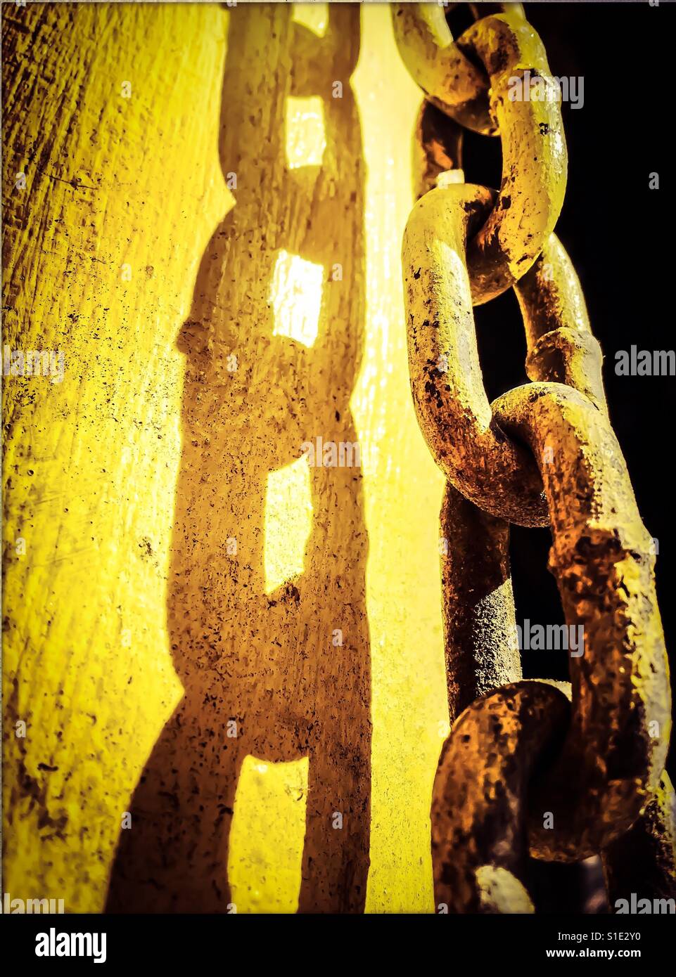 Yellow chain links linked together close on Stock Photo Alamy