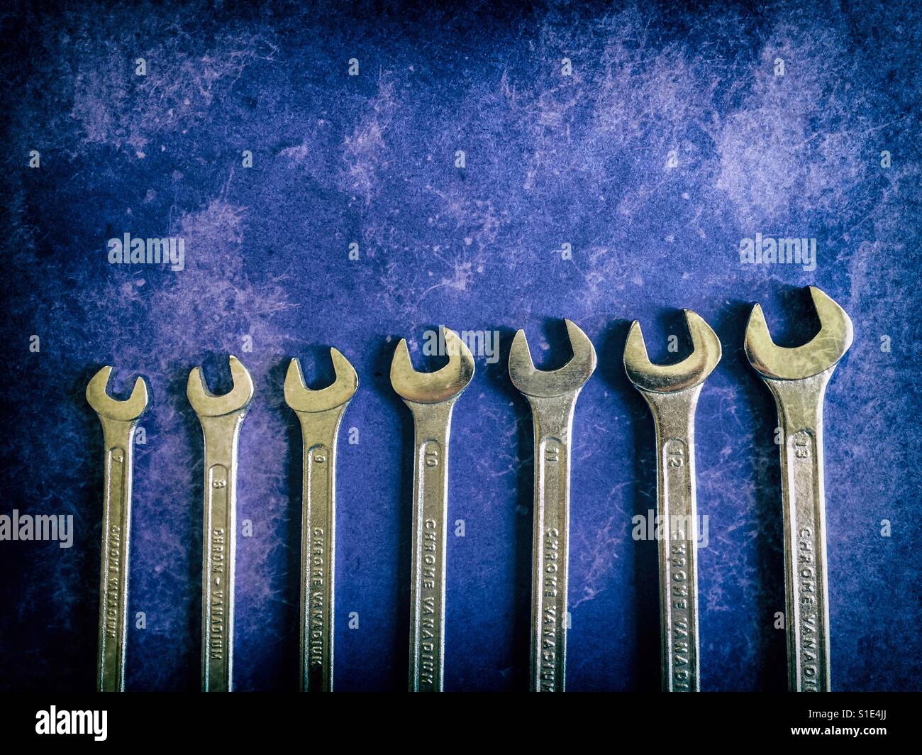 Set of metal wrenches on a blue grungy background - Smartphone Captured Stock Image