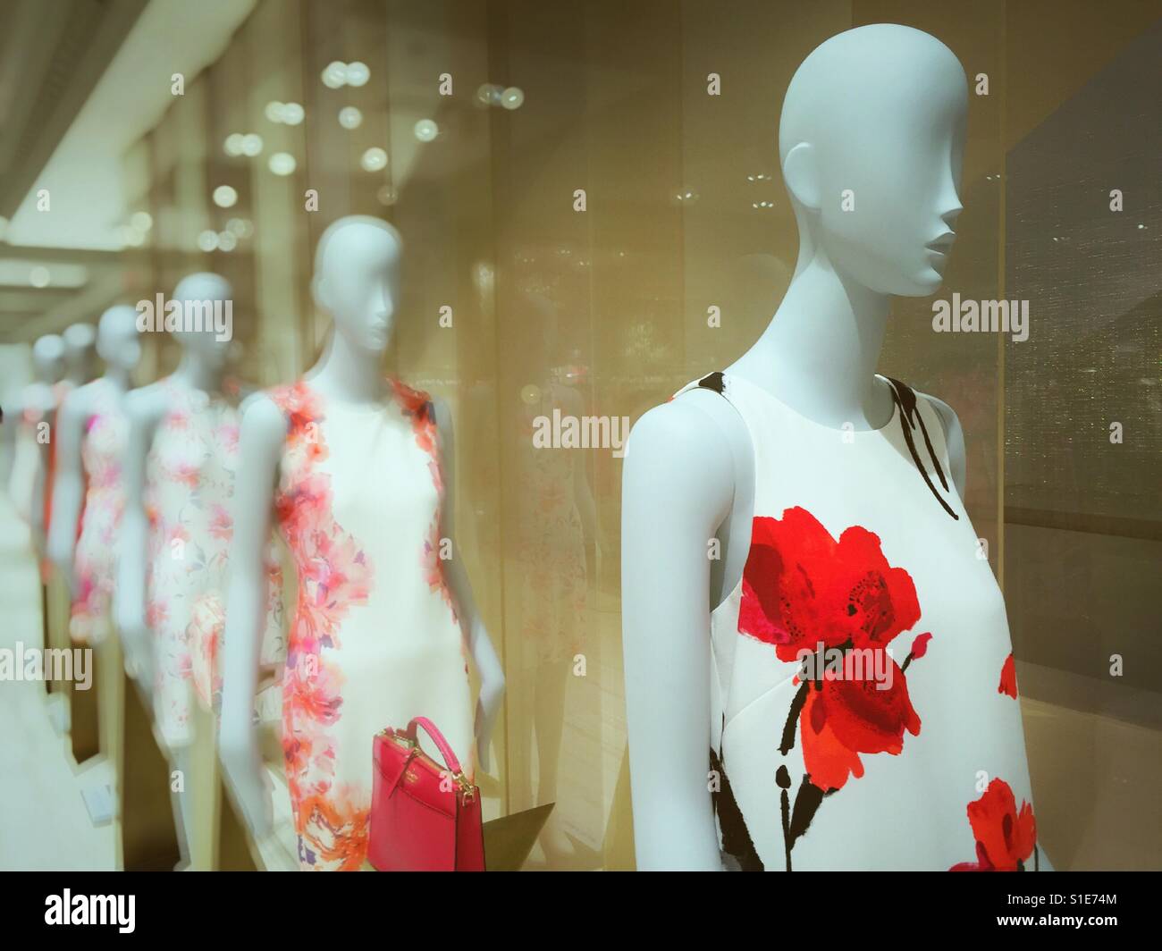 Mannequins wearing summer dresses in window display at Lord and Taylor department store, NYC, USA Stock Photo