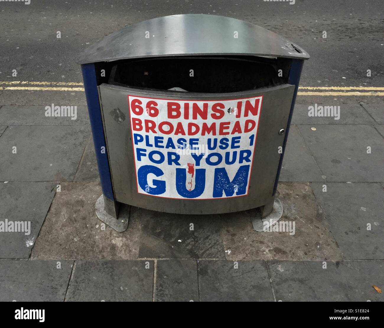 A litter bin in Bristol, UK with a sign urging gum chewers to use it to dispose of their used gum - Smartphone Captured Stock Image