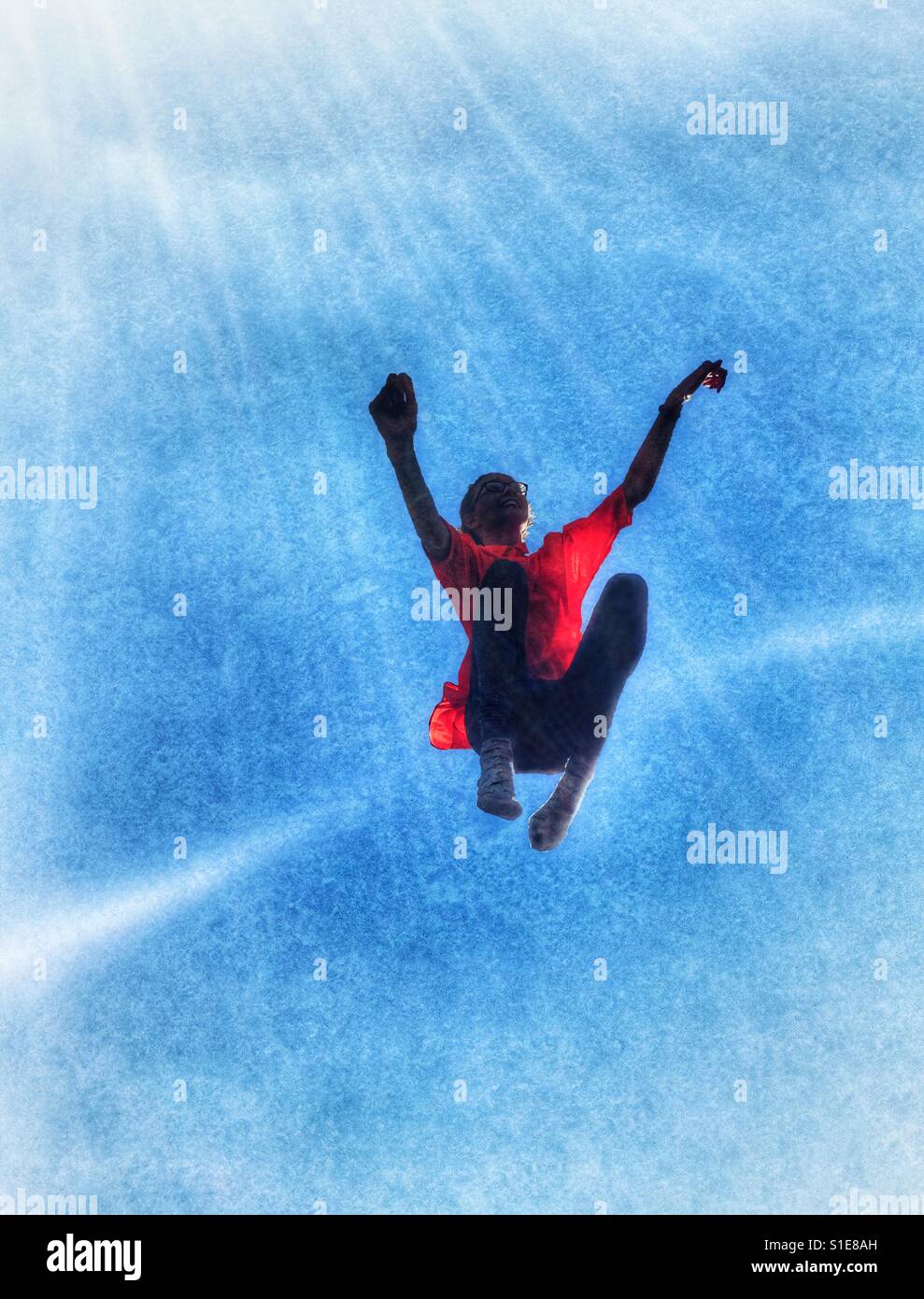 Girl jumping against a blue sky Stock Photo - Alamy