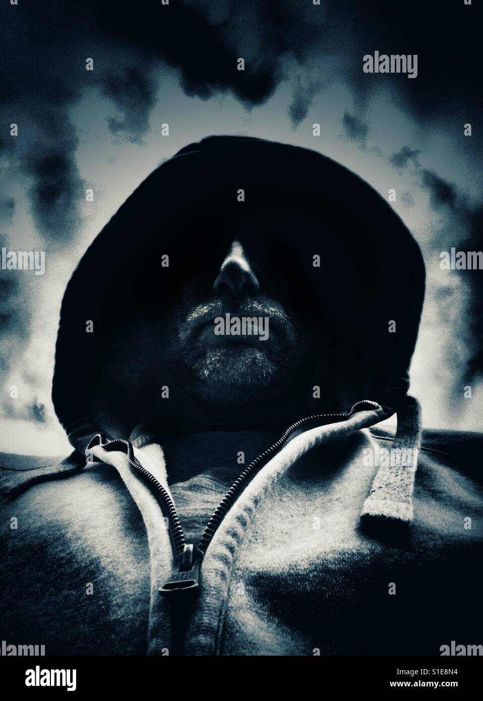 Man with hood with face in shadow - Smartphone Captured Stock Image Man with hood with face in shadow - Smartphone Captured Stock Image