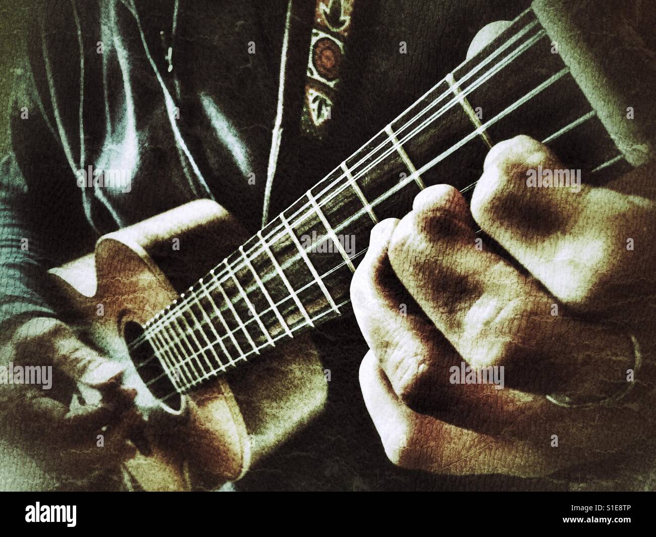 Musician playing a 5 string tenor ukulele. Double course 4th string, low g / high g Stock Photo