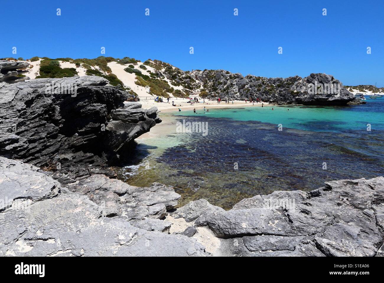 A beautiful rocky cove on a pristine white sand beach on Rottnest Island, Perth. Stock Photo