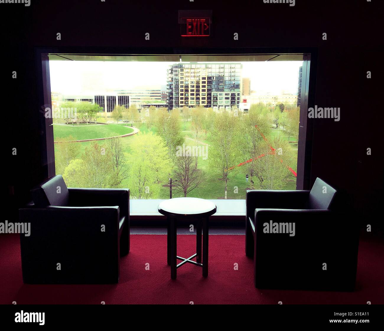 Chairs and table next to a picture window at the Guthrie Theater in Minneapolis, Minnesota, USA. Stock Photo