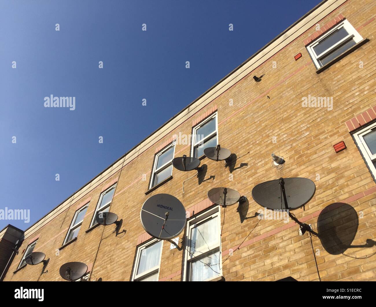 Satellite dishes on houses, East London, England Stock Photo Alamy