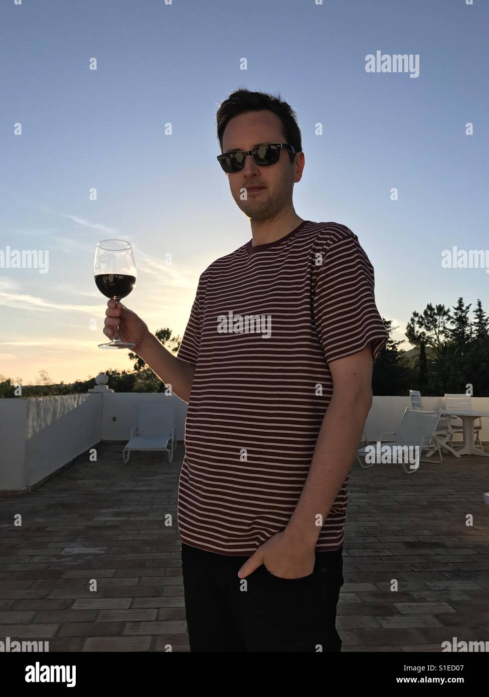 Man with glass of red wine Stock Photo