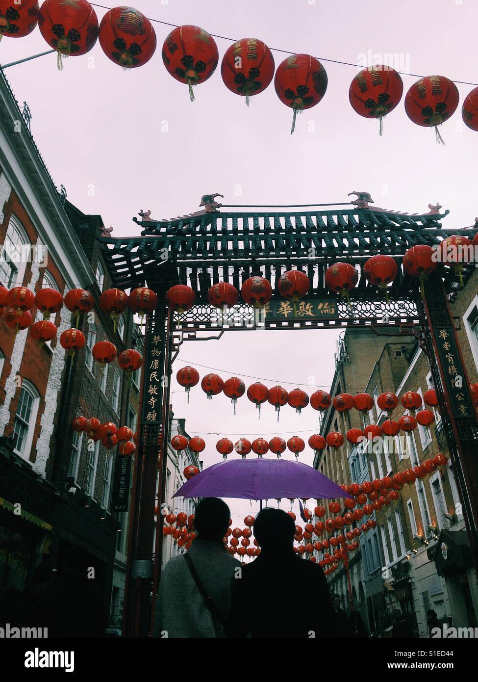 People walking in China Town of London on a rainy day May 2017 - Smartphone Captured Stock Image