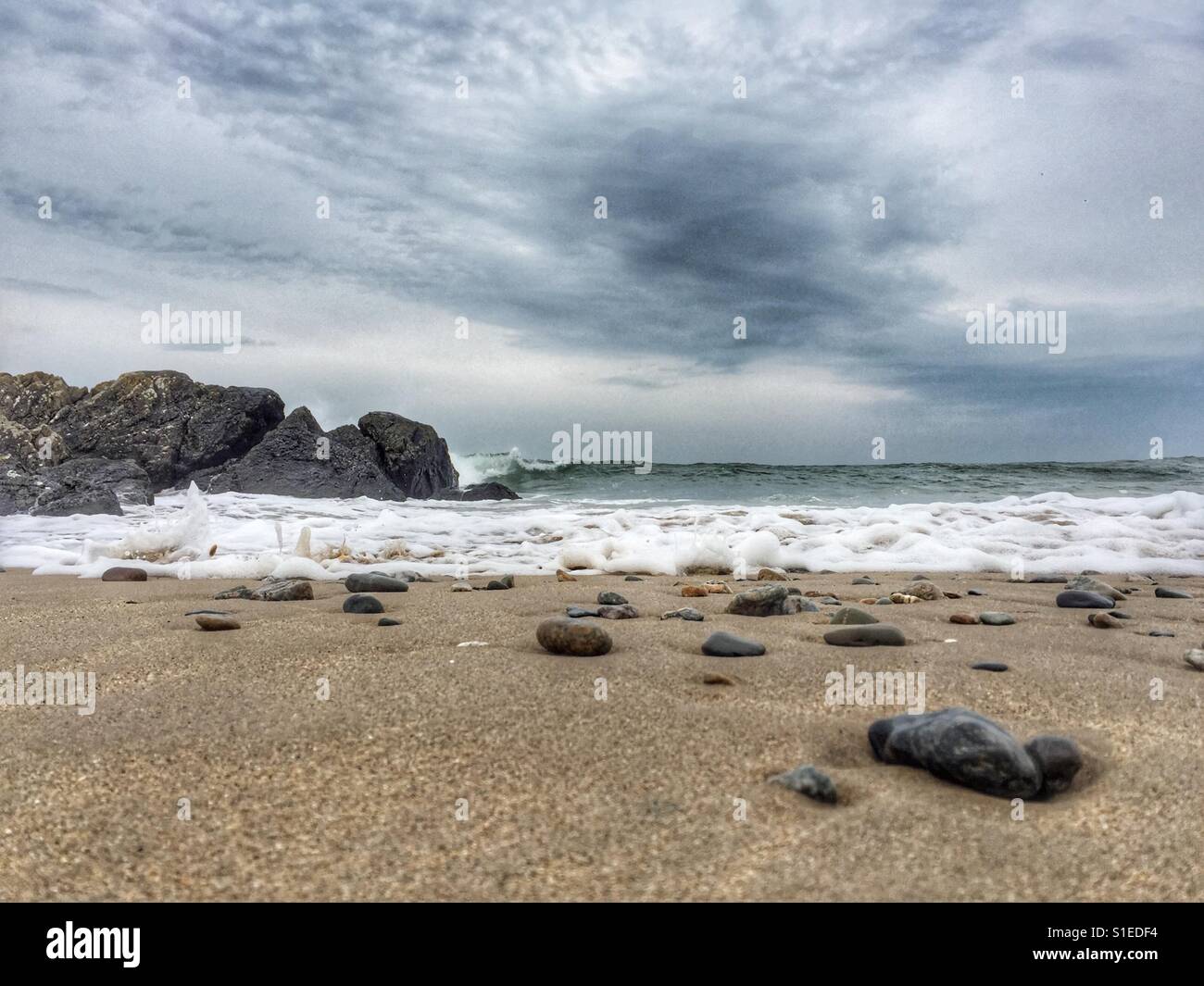 Tide rushing in on beach - Smartphone Captured Stock Image