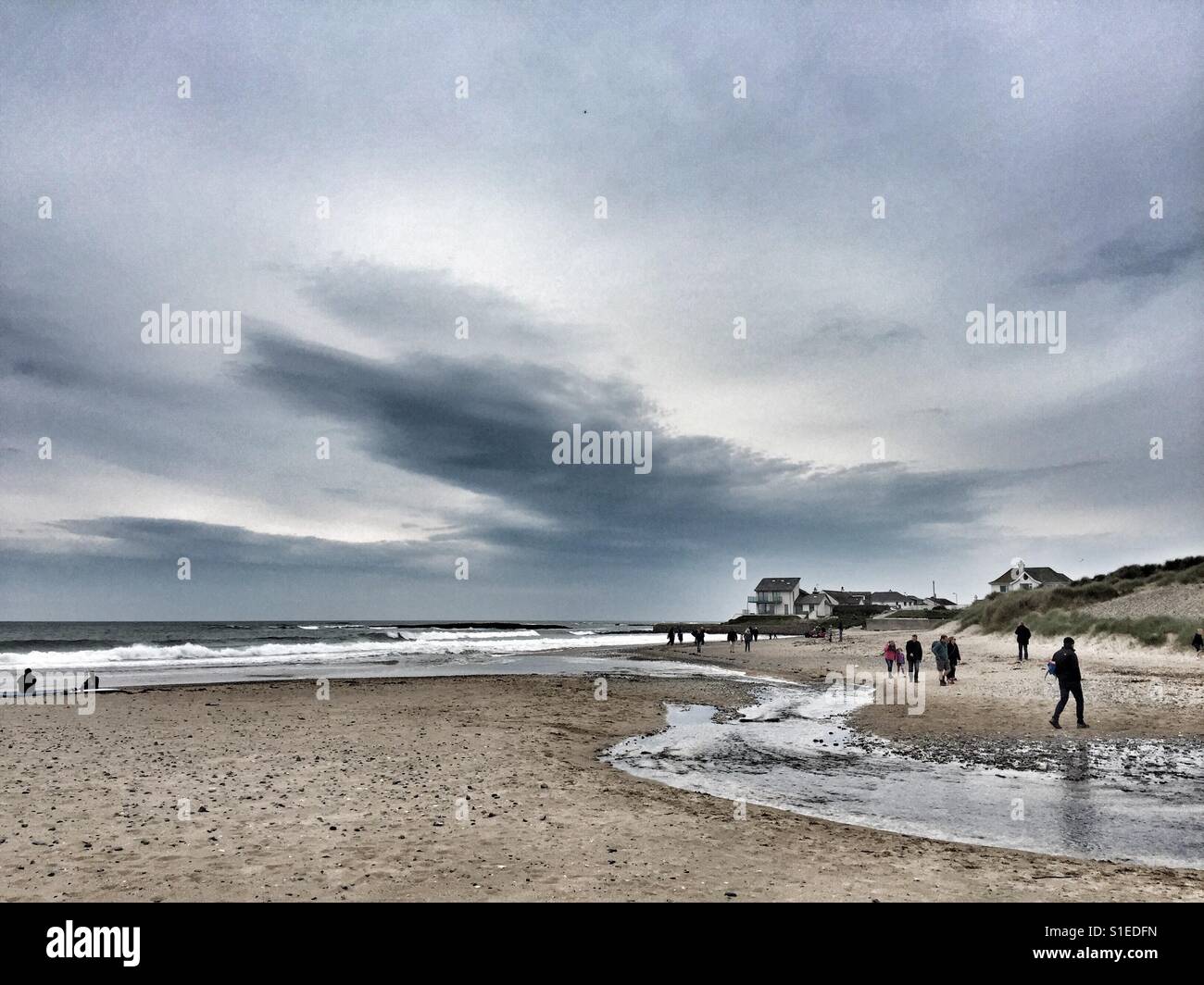 Walkers on Broad Beach, Rhosneigr, Anglesey, North Wales - Smartphone Captured Stock Image