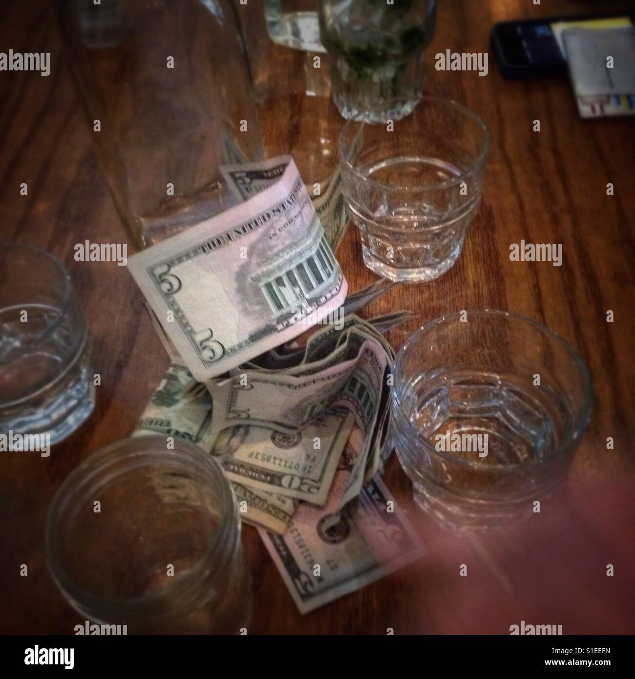 Paying the bill or leaving a tip? - Smartphone Captured Stock Image