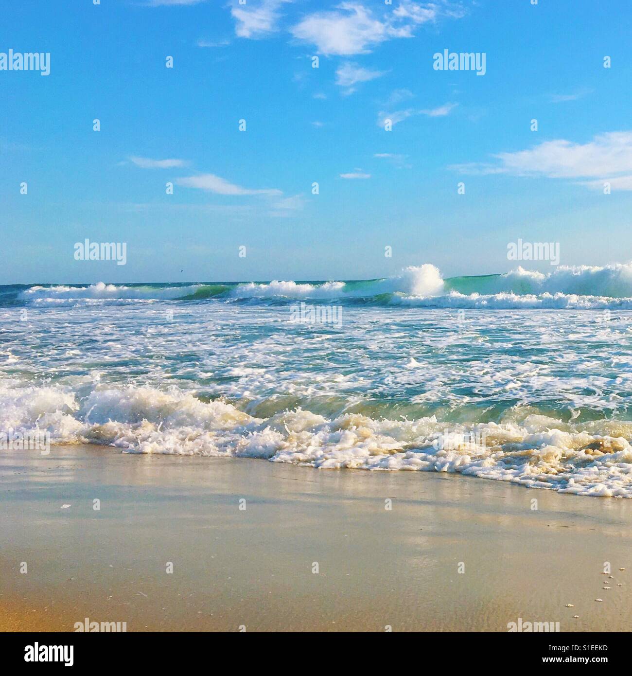 View of ocean from a sandy beach. Square crop. 1x1 ratio. Space for copy. - Smartphone Captured Stock Image