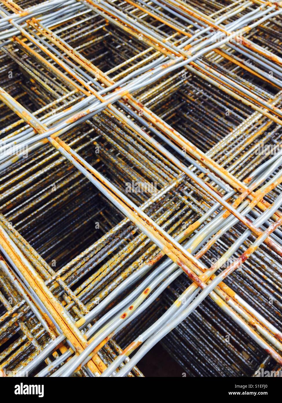 Stacked, rusty construction materials in a grid. - Smartphone Captured Stock Image
