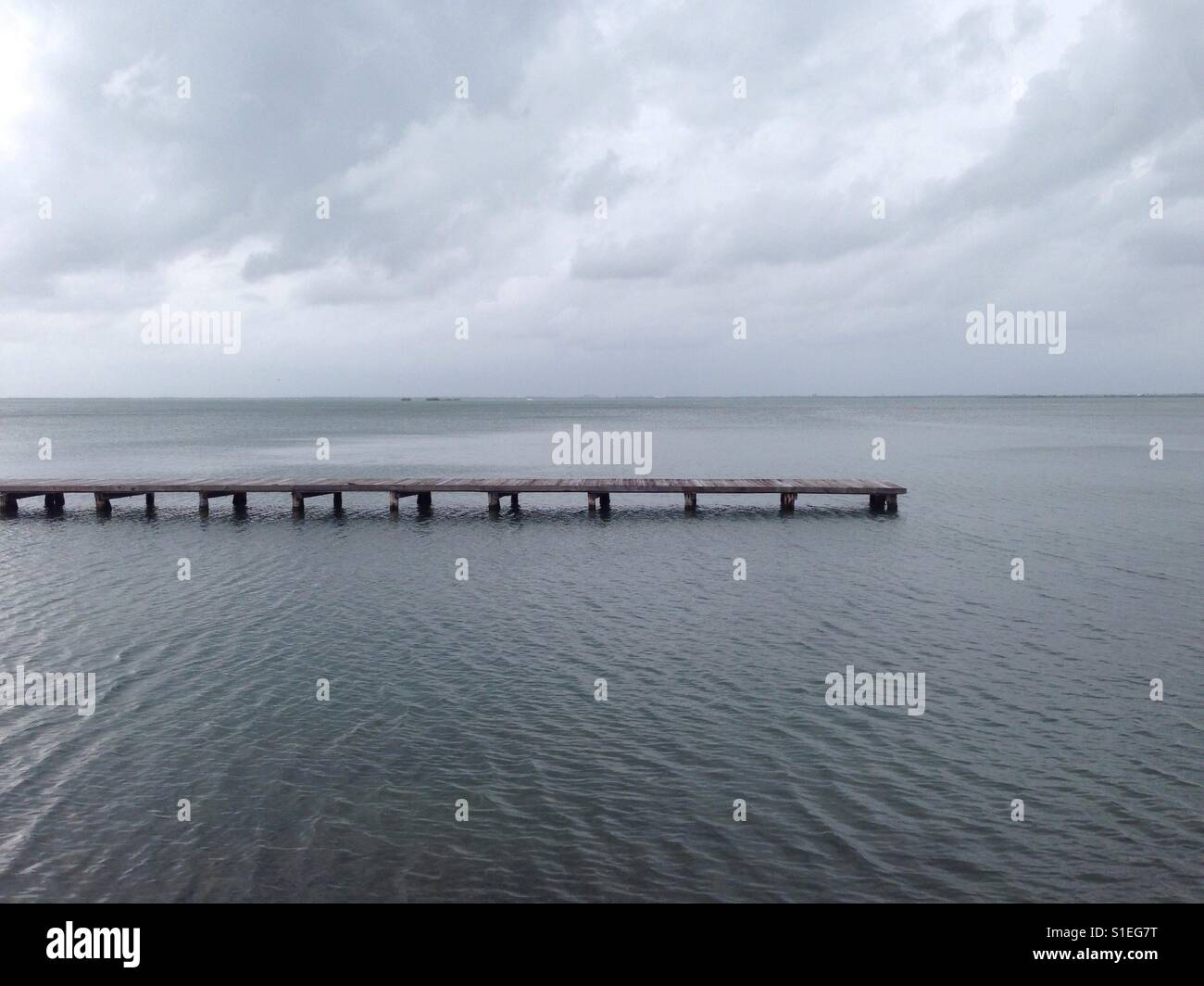 Wood bridge in the sea Stock Photo - Alamy