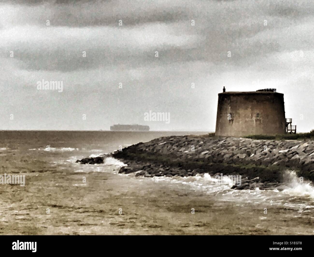 Rock armour protecting a Historic Martello Tower from coastal erosion, East Lane, Bawdsey, Suffolk, UK. - Smartphone Captured Stock Image