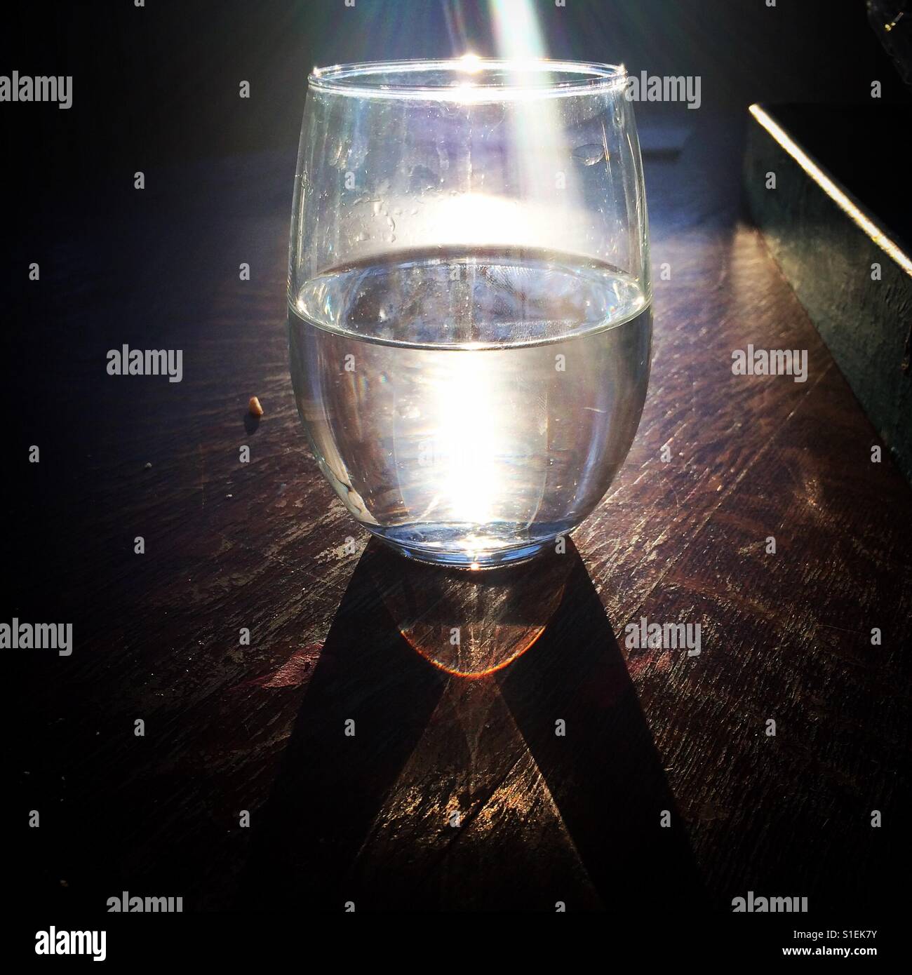 Glass of water with sunflare Stock Photo