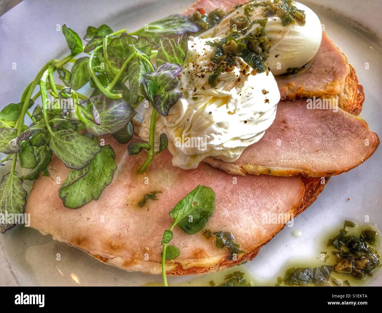 Baked ham, poached eggs, and pea shoots on toast - Smartphone Captured Stock Image