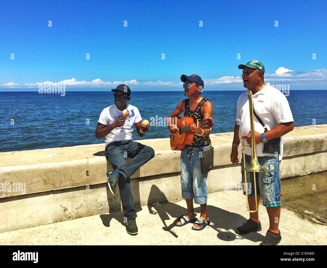 Cuban musicians performing with ocean on the background - Smartphone Captured Stock Image