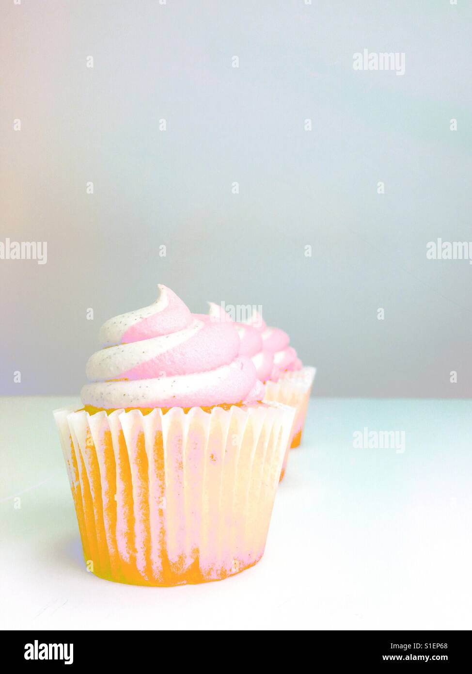Line up of three strawberry cupcakes. Space for copy. - Smartphone Captured Stock Image