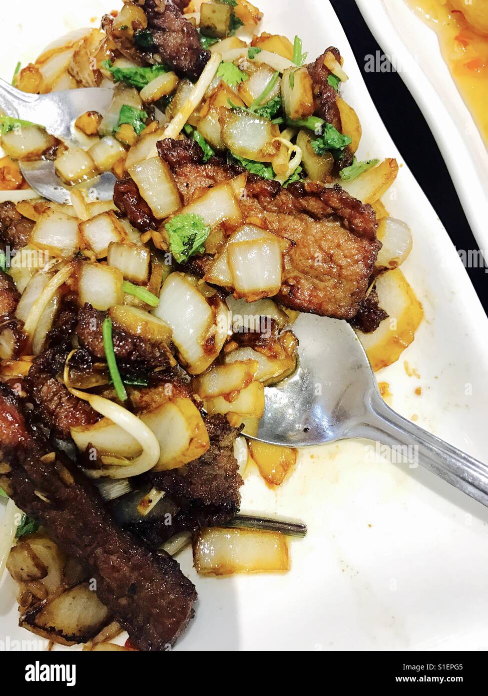 Chinese fillet steak in chilli, coriander and onion sauce Stock Photo