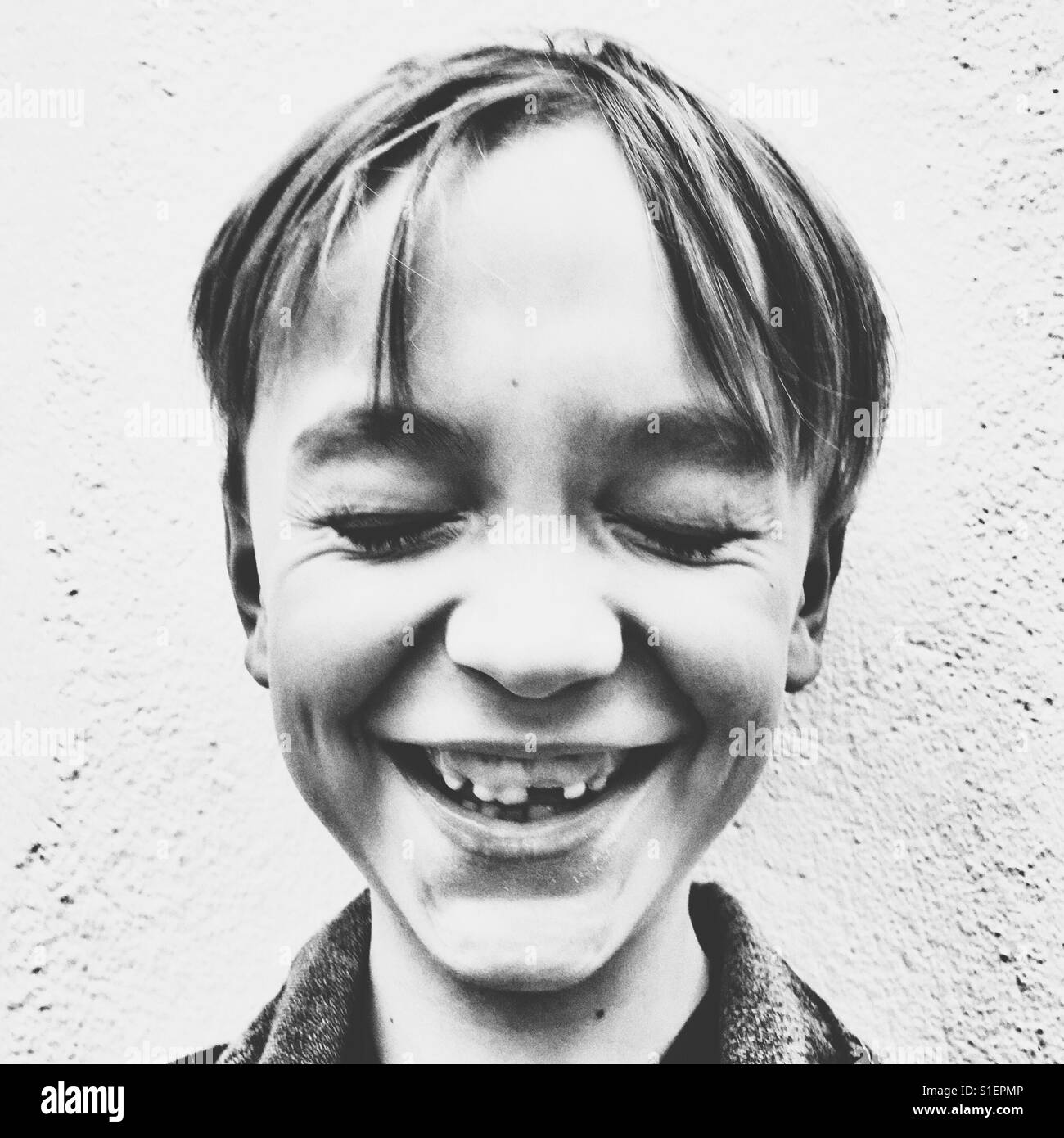 Child missing front tooth laughing - Smartphone Captured Stock Image