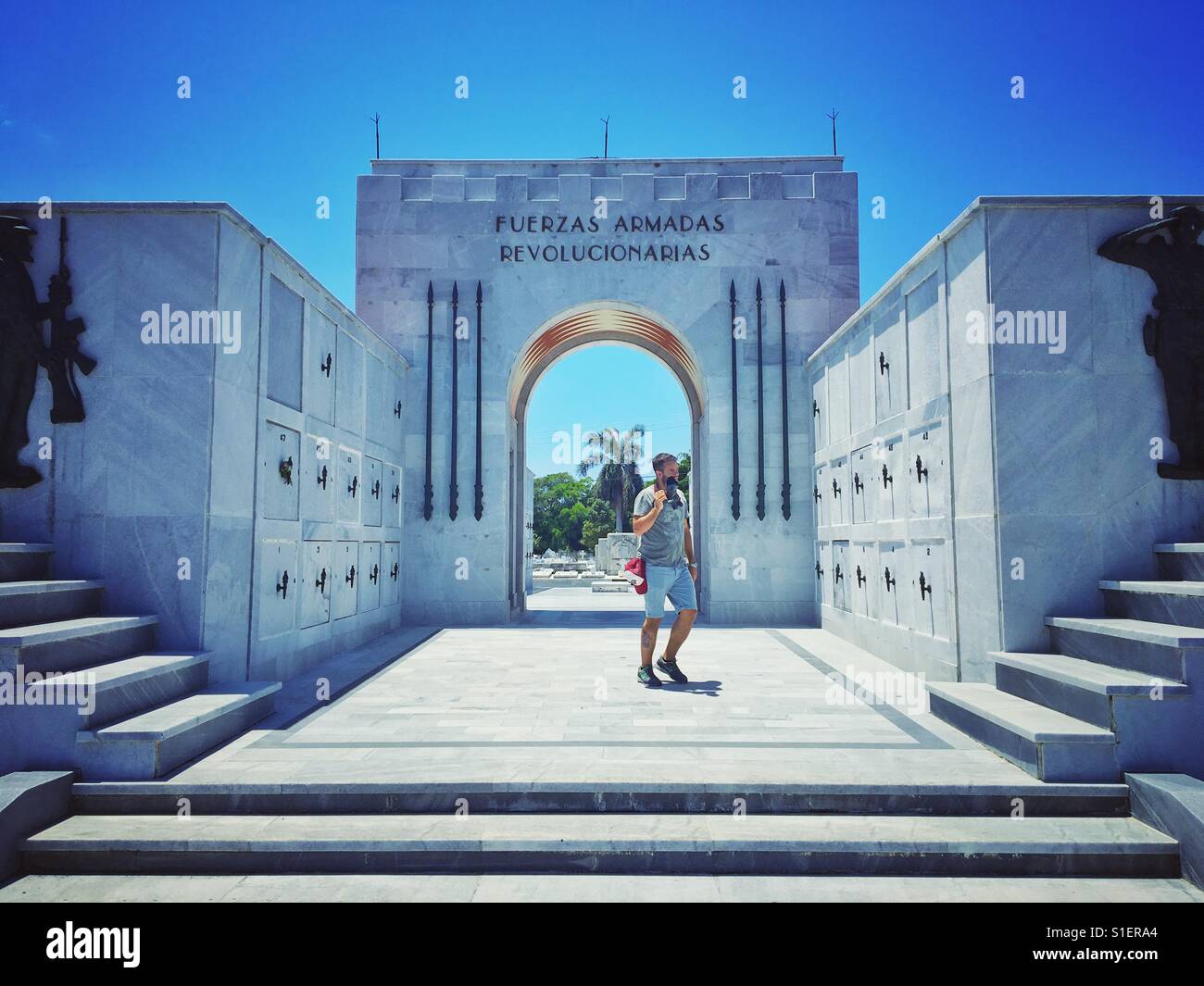 Photographer looking with attention at the cemetery in Havana, Cuba - Smartphone Captured Stock Image
