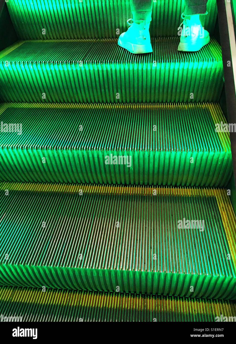 Green lighted escalator Stock Photo Alamy