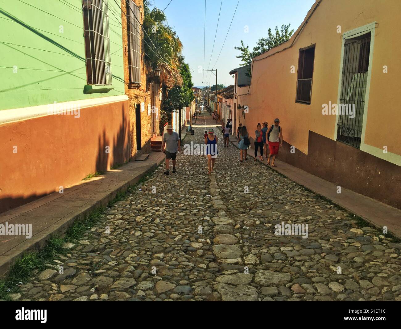People walking in a street of Trinidad, Cuba - Smartphone Captured Stock Image