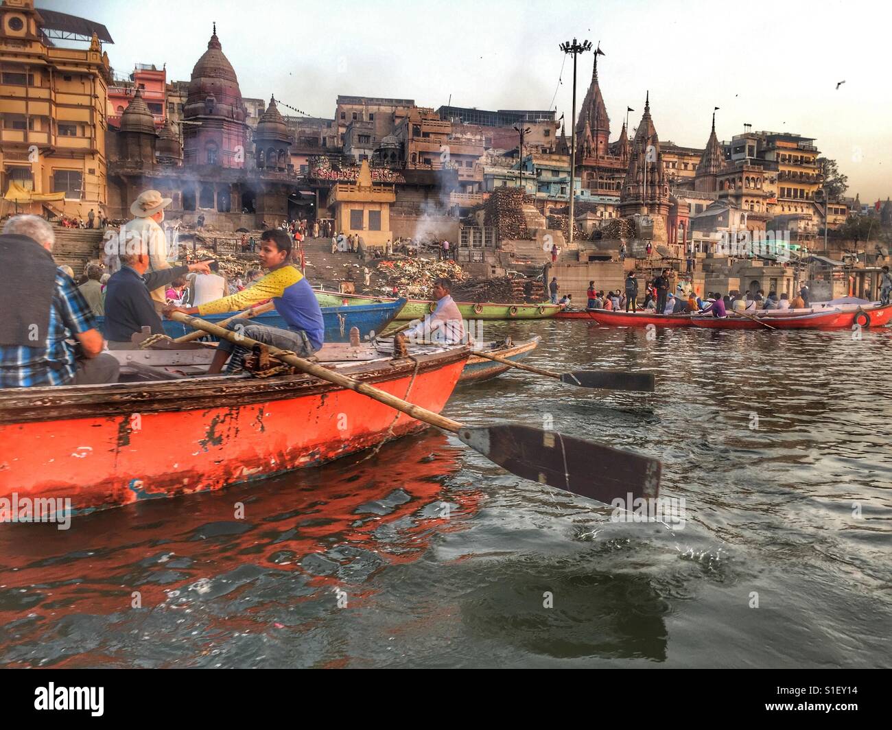 Tourists on boats on the river Ganges view the ghats from afar, Varanasi, India - Smartphone Captured Stock Image