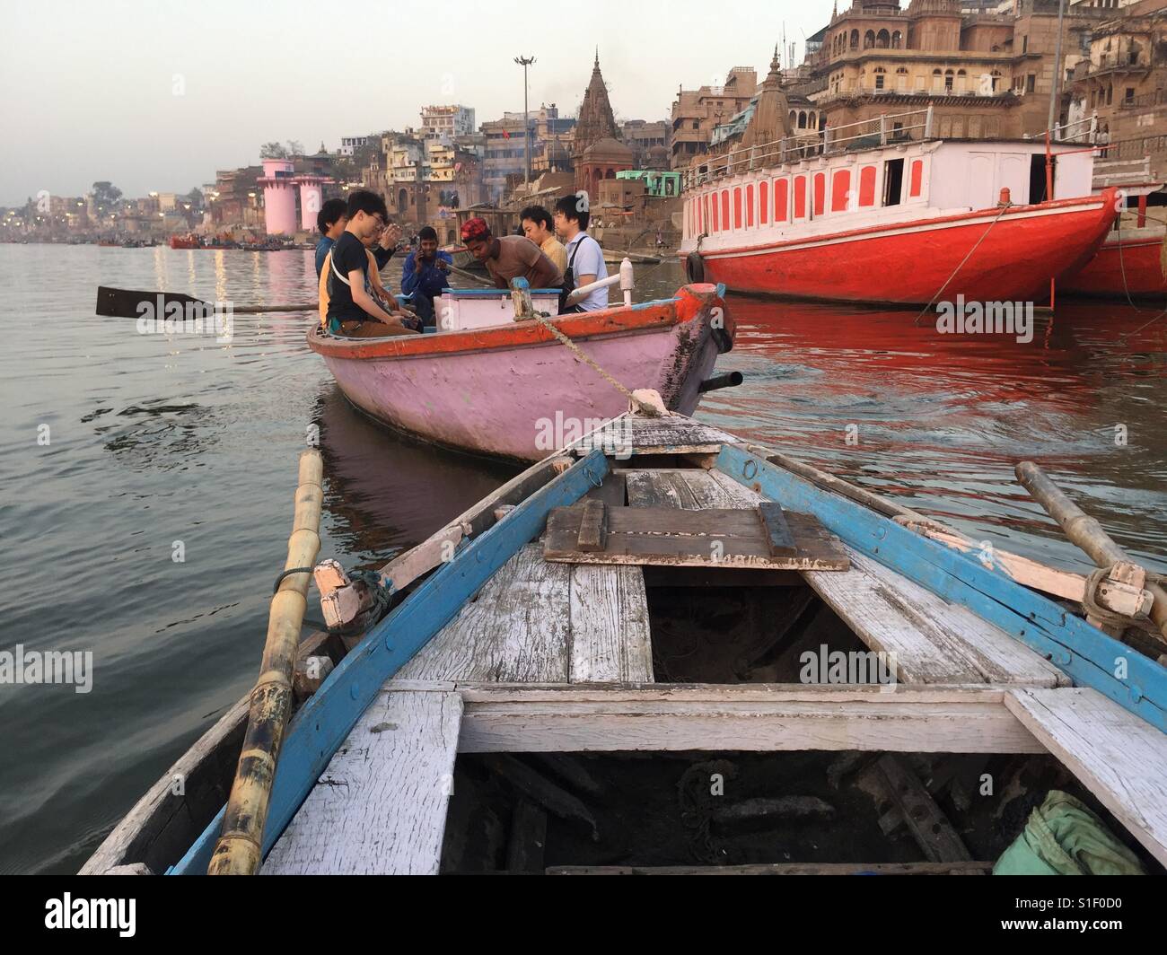 Tourists in a boat on the river Ganges in Varanasi, India - Smartphone Captured Stock Image