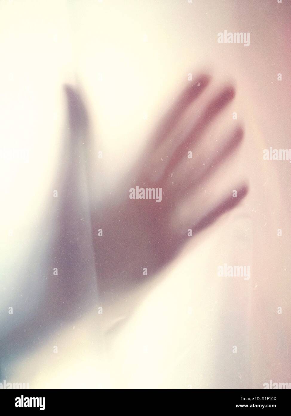 Hand behind a shower curtain - Smartphone Captured Stock Image