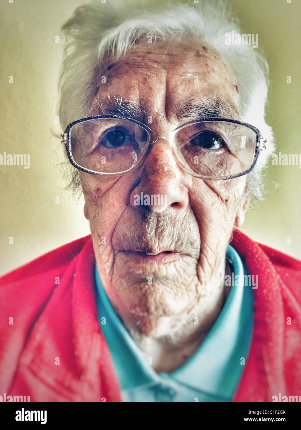 Elderly woman suffering from macular degeneration in her eyes Stock Photo