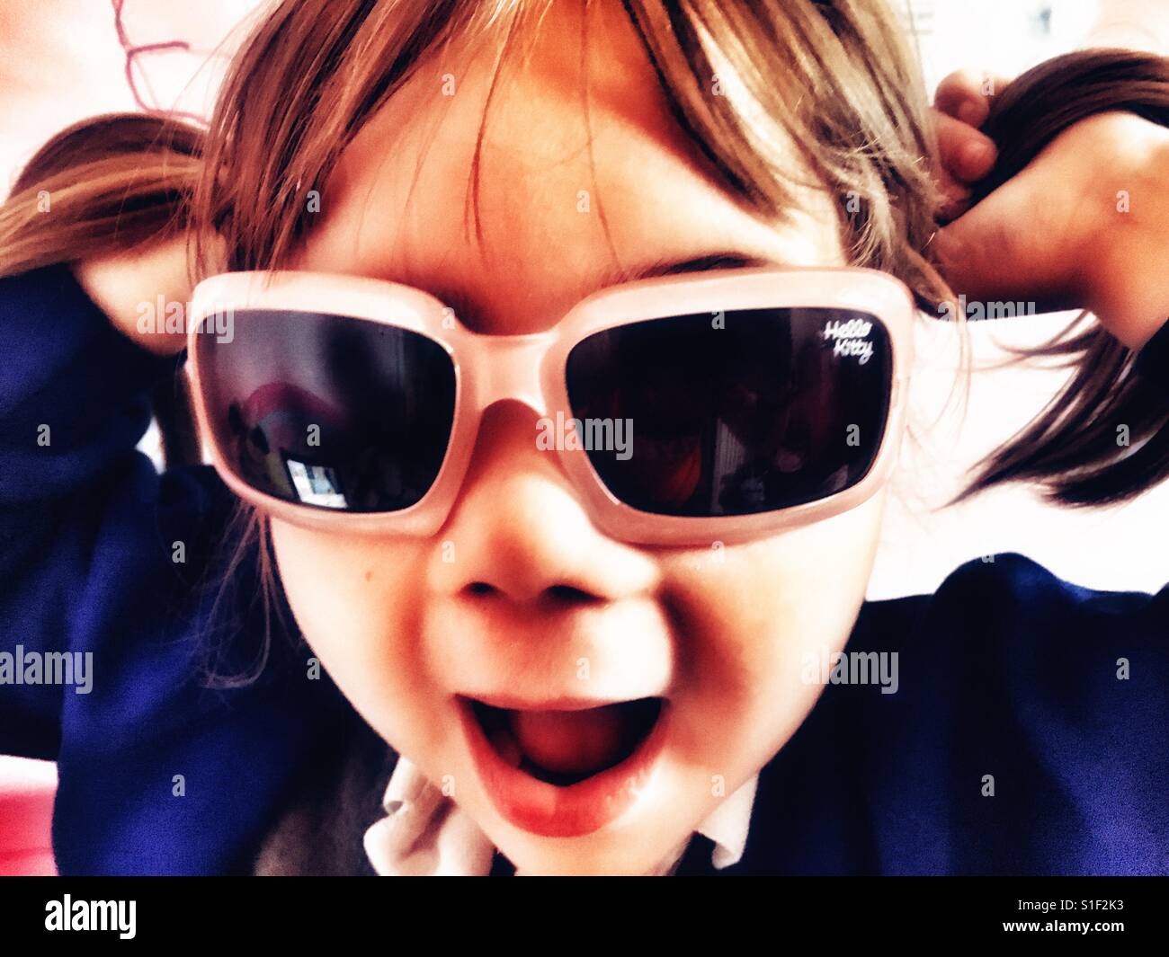Girl in Sunglasses with pigtails Stock Photo