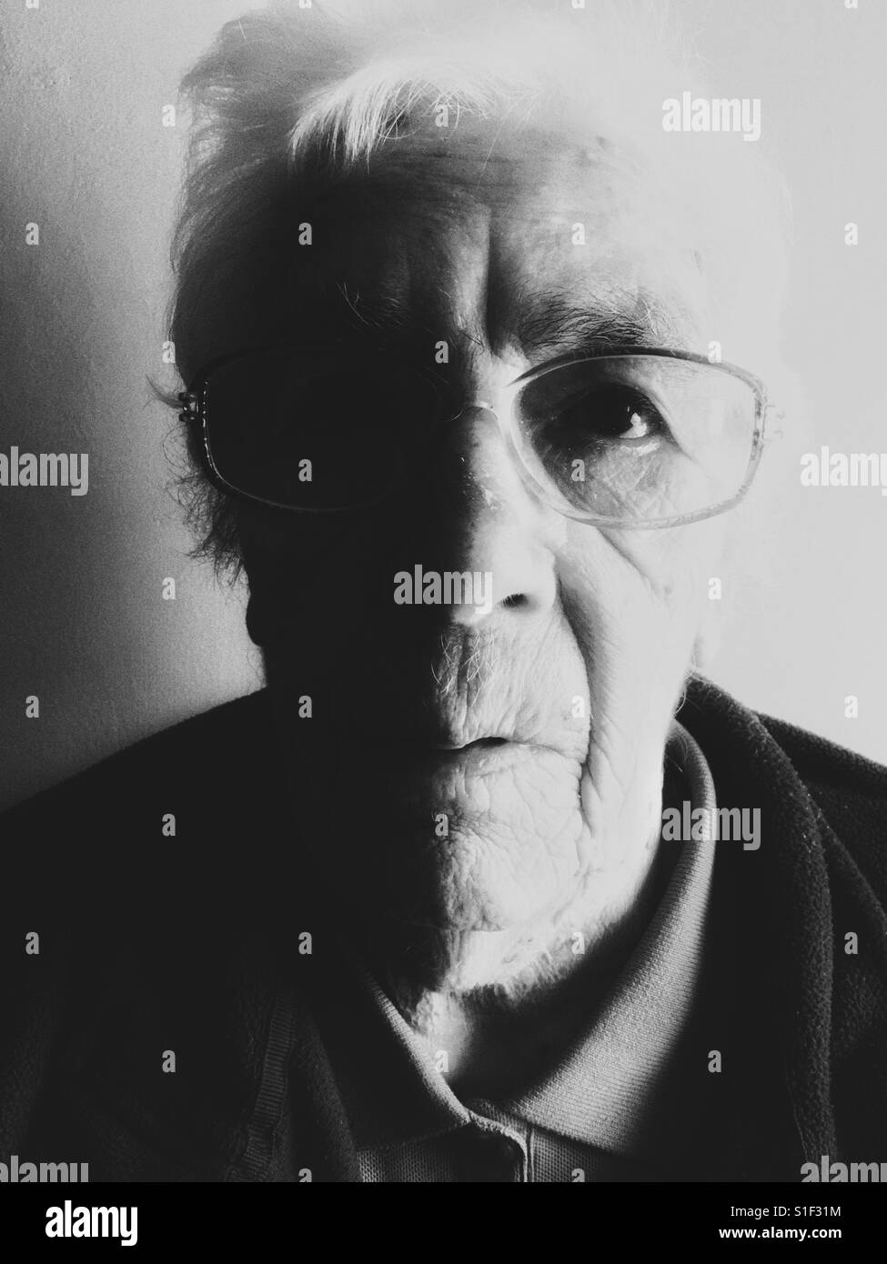 Elderly woman suffering from macular degeneration in her eyes - Smartphone Captured Stock Image