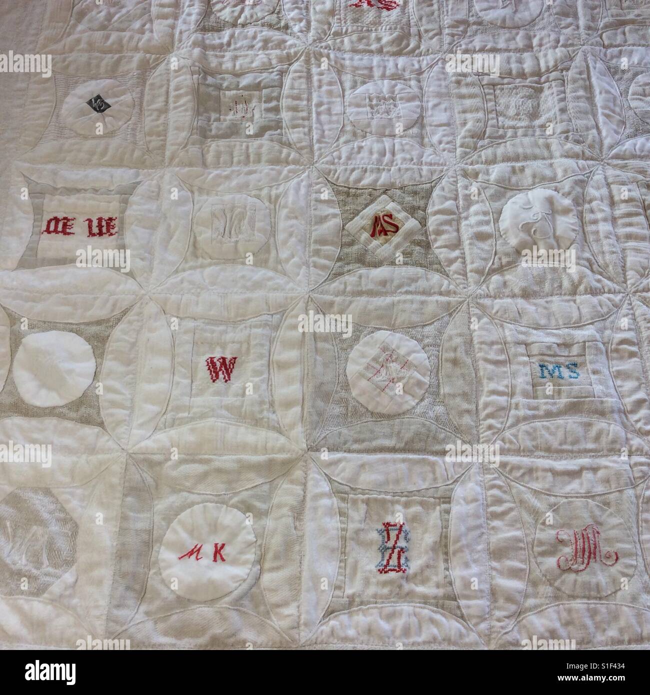 Quilt made from vintage table cloth, bed linen and dish cloth Stock Photo