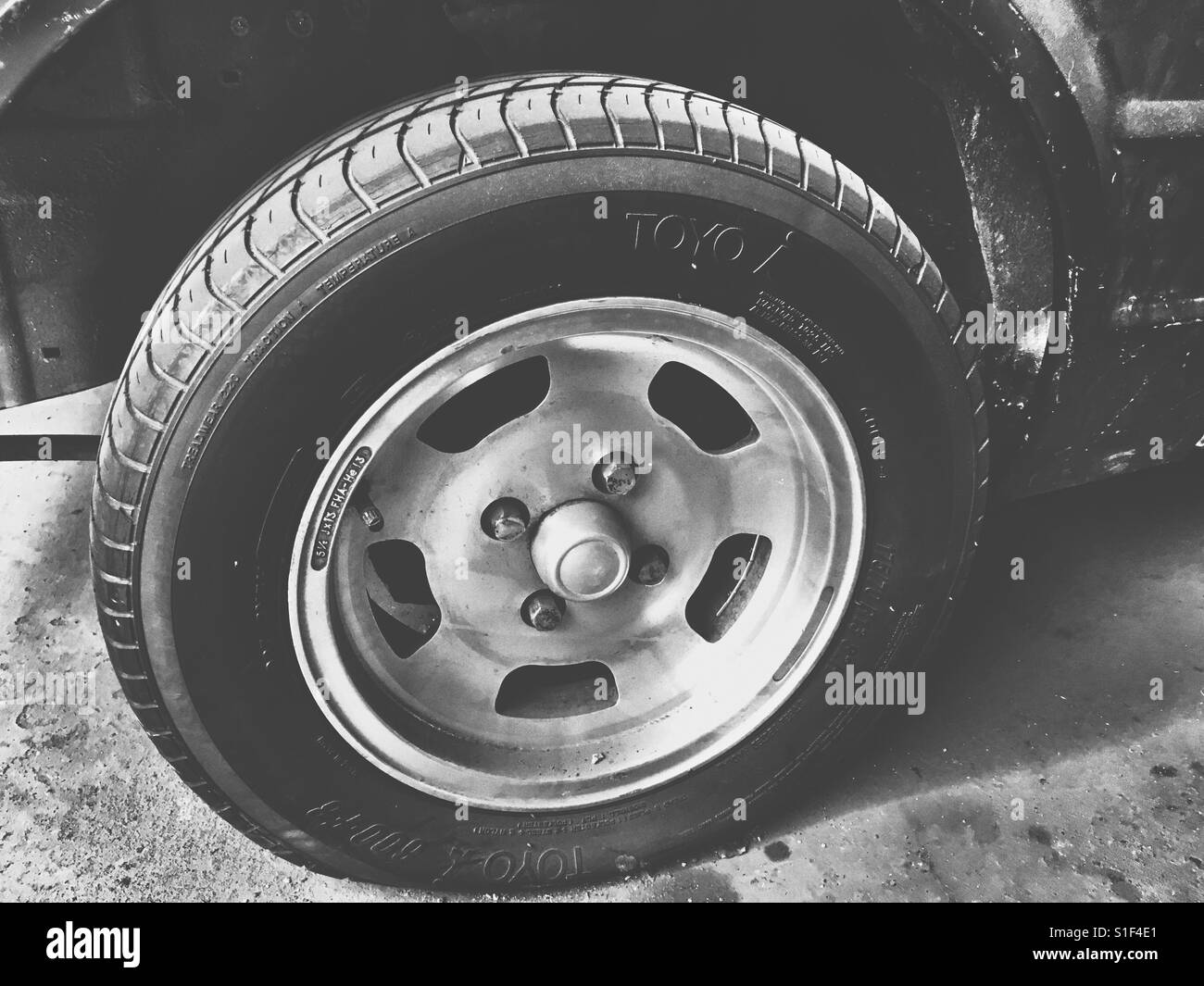 Vintage Ford Escort MK 4 wheel with flat tyre. Stock Photo